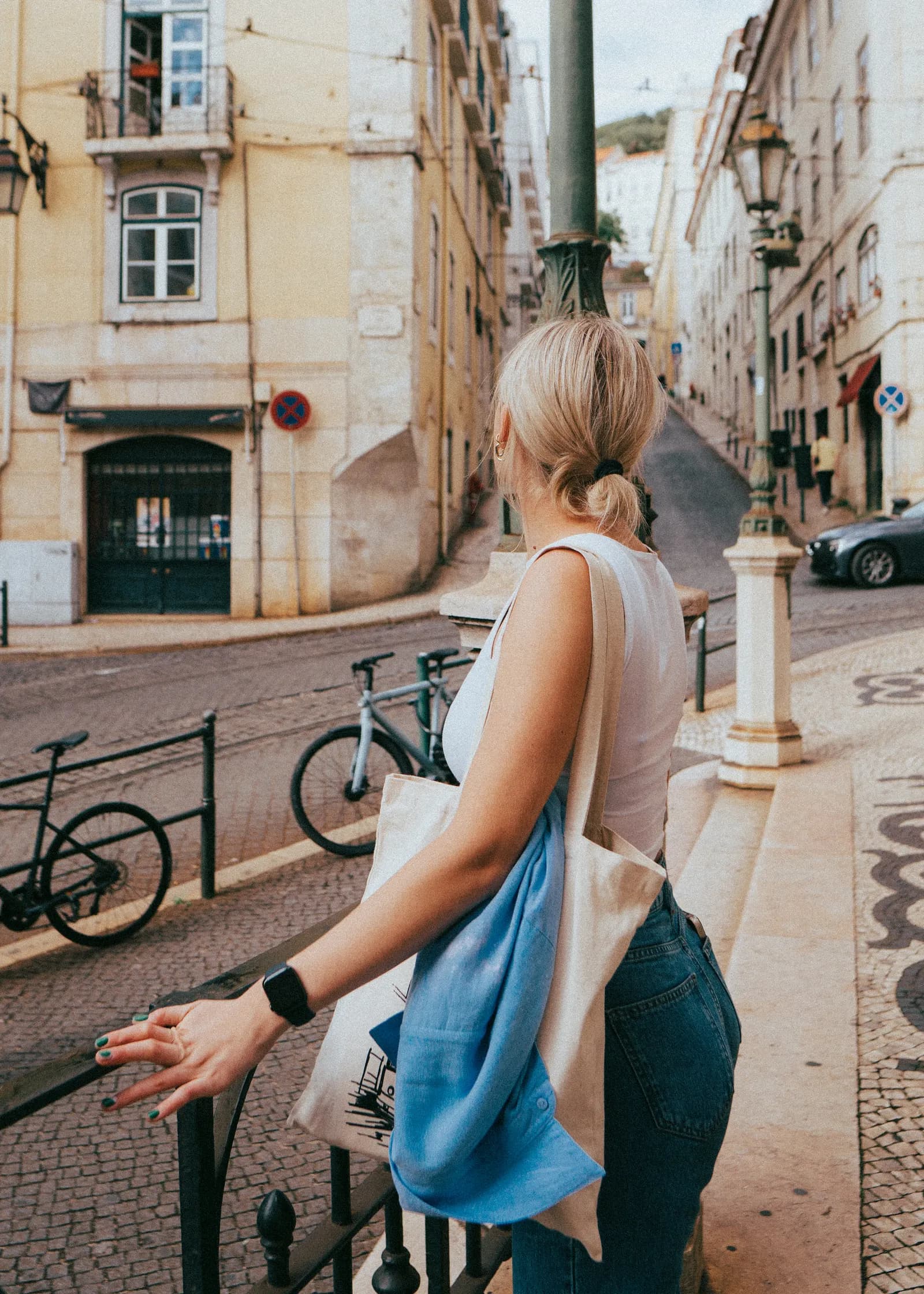 Woman sightseeing on a Lisbon street with a guide leaflet