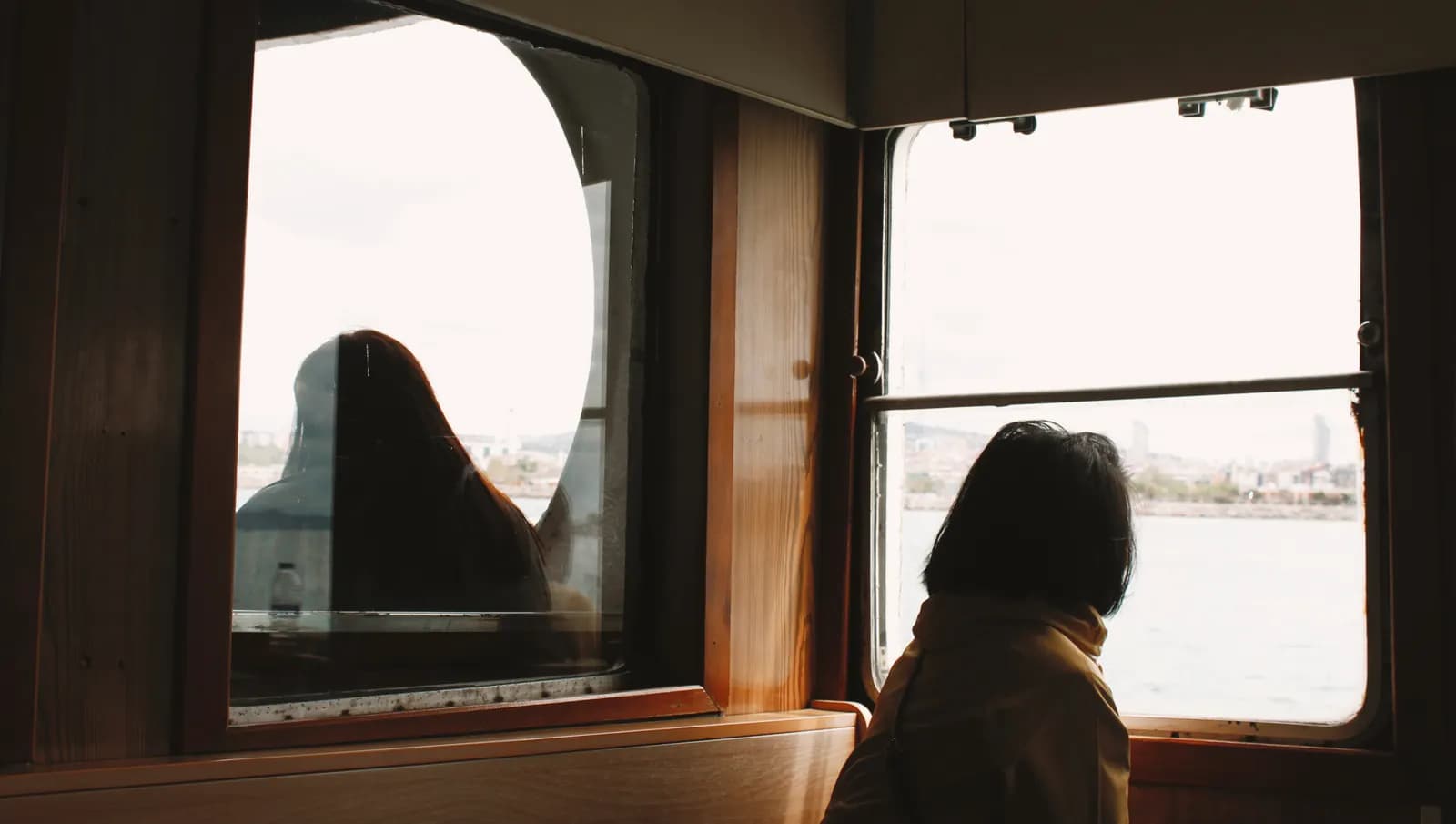 Woman looking through a ferry window in Istanbul